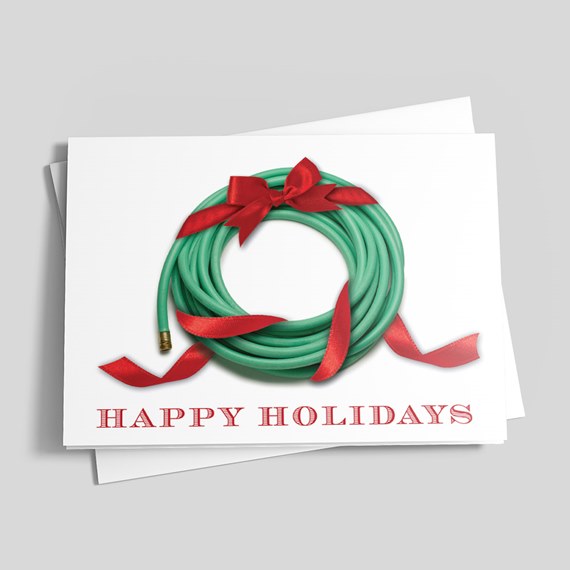 Holiday greeting card with green garden-hose wreath, red ribbon and 'HAPPY HOLIDAYS' text