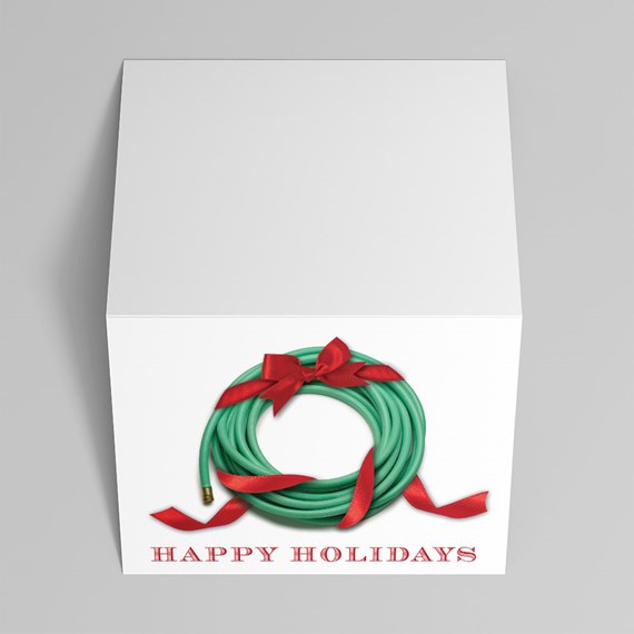 White gift box with green hose wreath, red ribbon and 'Happy Holidays' text