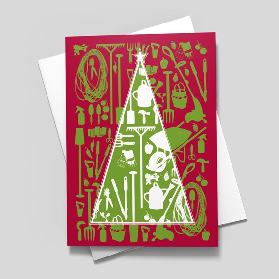 Folded holiday card with Christmas-tree shape composed of gardening tool silhouettes in green and white on a red background, shown with a white envelope.
