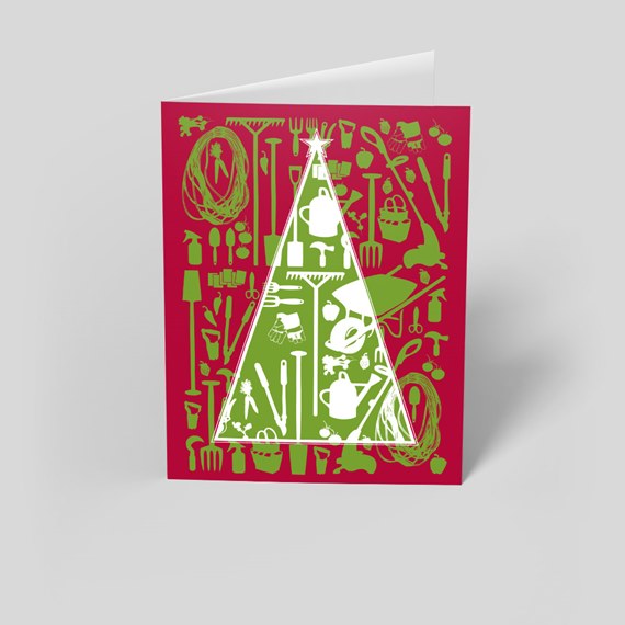 folded red holiday card with white-outlined tree filled with green gardening tool silhouettes