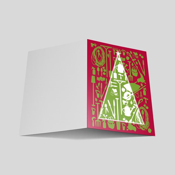 Folded holiday greeting card with burgundy front featuring a green and white tree made of gardening tools; blank interior