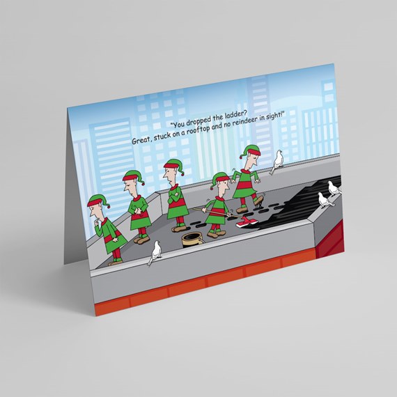 Folded greeting card with cartoon elves on a rooftop, pigeons and city skyline, humorous caption about a dropped ladder and no reindeer.