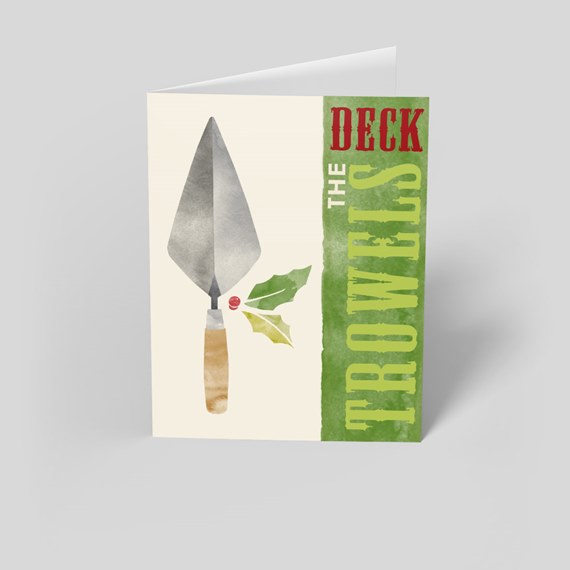 Folded holiday greeting card showing a watercolor trowel, holly with red berry, and a green vertical stripe with text on a cream background.