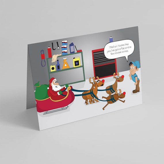 Folded greeting card showing cartoon Santa in sleigh pulled by reindeer and a mechanic in a garage with a humorous speech bubble