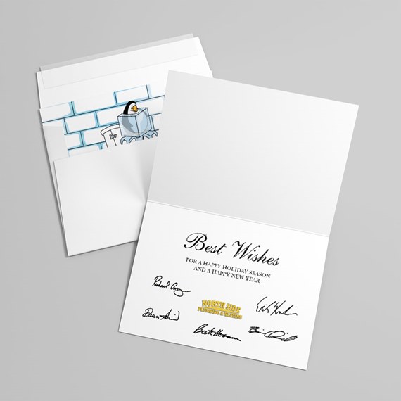 Folded holiday greeting card with 'Best Wishes' message, signatures and gold logo, shown with an envelope featuring a penguin illustration.