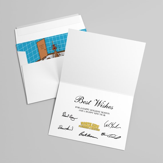 Open white folded greeting card with printed Best Wishes message and signature-style graphics, paired with envelope showing a blue tiled illustrated liner.