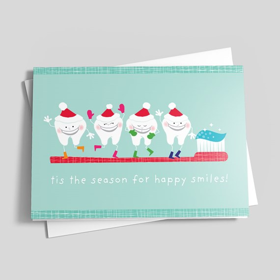 Holiday greeting card: smiling cartoon teeth in Santa hats on a red toothbrush with toothpaste and the phrase 