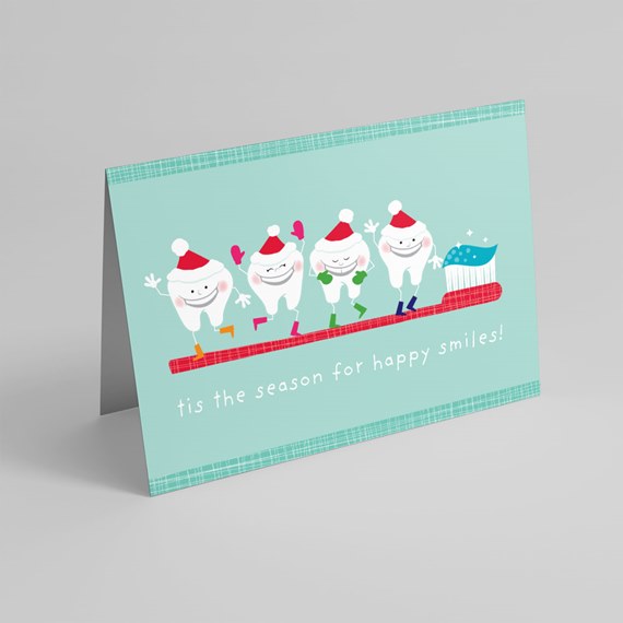 Holiday greeting card with smiling cartoon teeth in Santa hats on a red toothbrush, mint-teal background