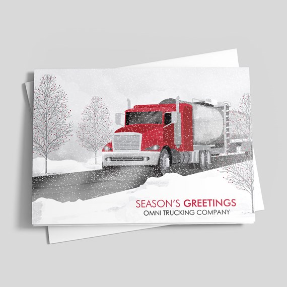 Season's Greetings holiday card with a red semi truck tanker driving through snow and bare trees