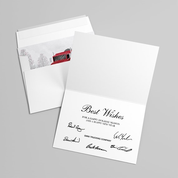 Open holiday greeting card with Best Wishes message and matching envelope showing a red truck illustration in a snowy winter scene