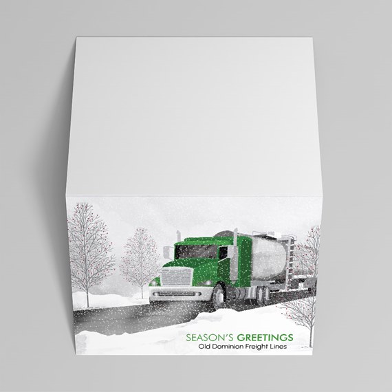 season's greetings card with green truck and snowy background