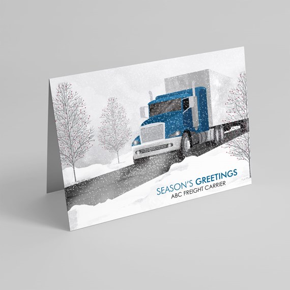 Folded holiday card with blue semi-truck in snowy landscape and 'Season's Greetings' text
