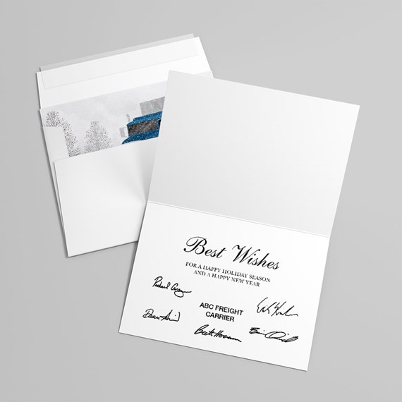 Folded white holiday greeting card with printed signatures and matching envelope showing a snowy scene with a blue truck