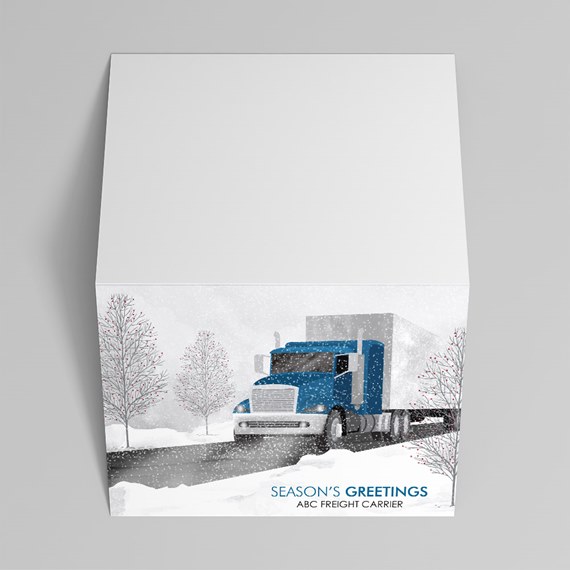 Gift box top with blue semi truck in a snowy winter scene, trees and 'Season's Greetings' text