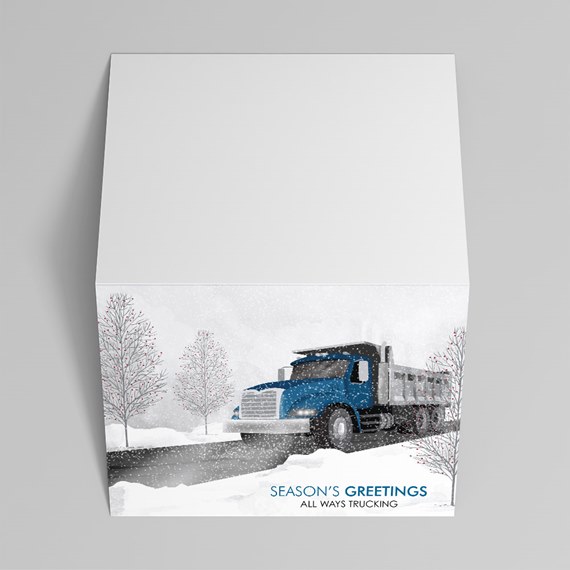 Holiday greeting box with blue semi truck illustration in a snowy winter scene with bare trees and falling snow