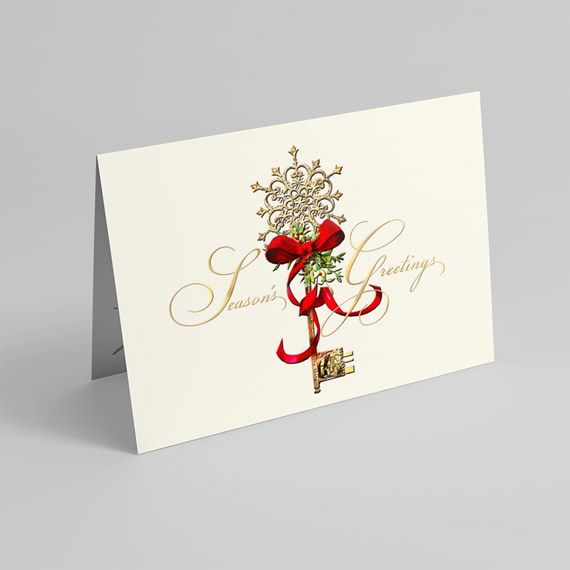 season's greetings card with decorative key and ribbon