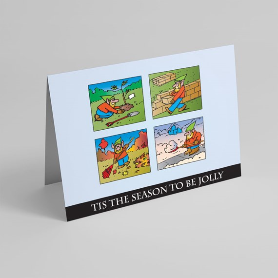 Light-blue folded greeting card with four cartoon panels of seasonal activities and a black strip reading 'Tis the season to be jolly'.
