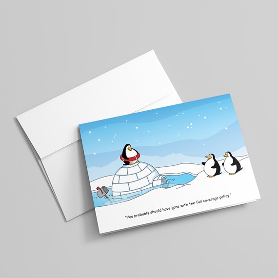 Folded greeting card with cartoon penguins, a partially submerged igloo and humorous caption; includes white envelope.