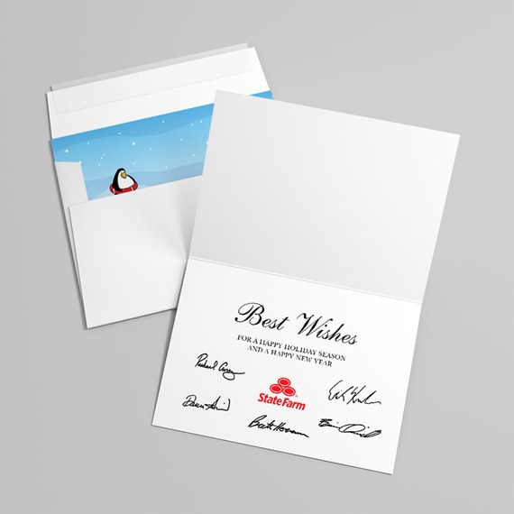 Folded holiday greeting card and envelope; interior blue snowy scene with a penguin. Inside lower panel displays 'Best Wishes' in script, a short holiday message, several printed signatures and a red company logo.