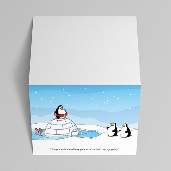 Folded greeting card with a cartoon igloo partly flooded, a penguin in a life preserver on top, two penguins on snow, and a humorous caption.