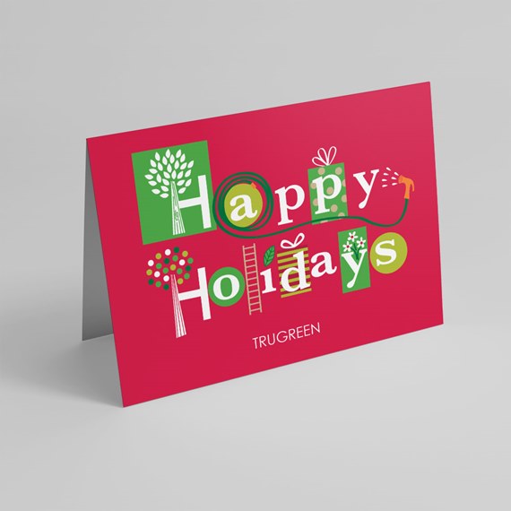 red folded greeting card with "Happy Holidays" lettering and green and white decorative icons