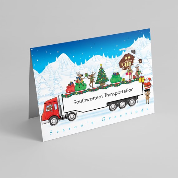 Folded holiday card with red semi truck carrying Christmas tree, gifts and reindeer in snowy mountains; white trailer panel for custom name and 'Season's Greetings' text at bottom.