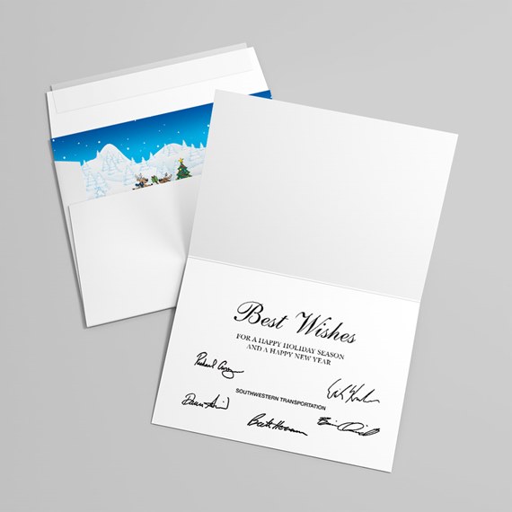 Open folded holiday greeting card with 'Best Wishes' and signatures, shown with envelope featuring a blue winter scene liner