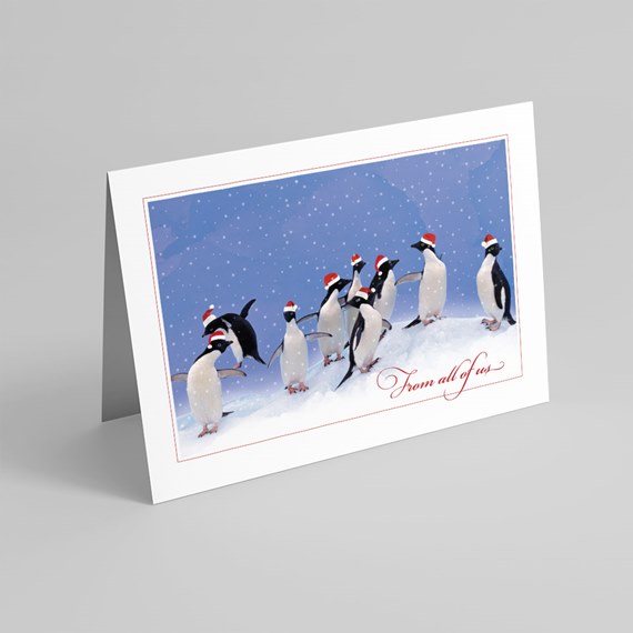 penguins in santa hats card with snowy background