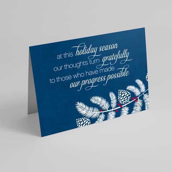 greeting card with decorative pine branches and text
