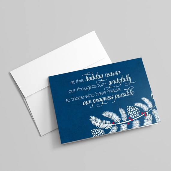 holiday greeting card with pine branches and text
