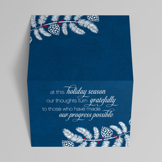 holiday greeting card design with pine branches and text