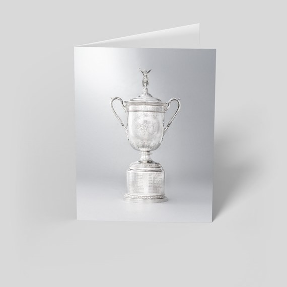 silver trophy with decorative handles and figure